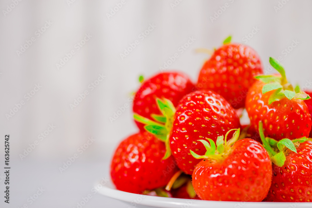 strawberries in bowl on wooden table with low key and copy space
strawberries in bowl on wooden table with low key and copy space