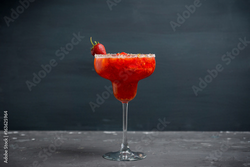 Cocktail strawberry margarita on the wooden background. Selective focus.