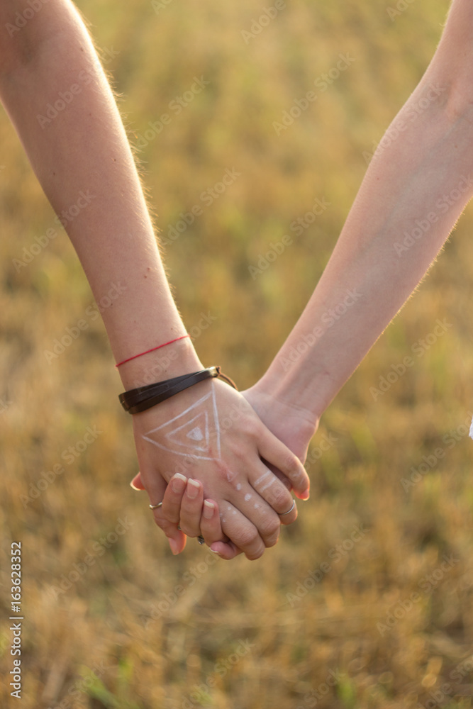 Two girlfriends holding hands Two girlfriends holding hands