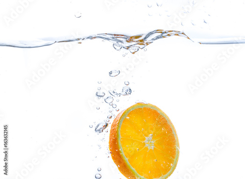orange slice in water splash. white  background