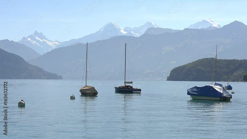 Boats floating on lake Thun Bernese Oberland Switzerland Boats floating on lake Thun Bernese Oberland Switzerland