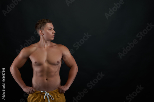 Tableau sur toile Front view of young man look to away to the copy space to advertising sport product
