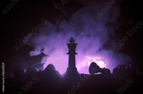 chess board game concept of business ideas and competition and strategy ideas concep. Chess figures on a dark background with smoke and fog
