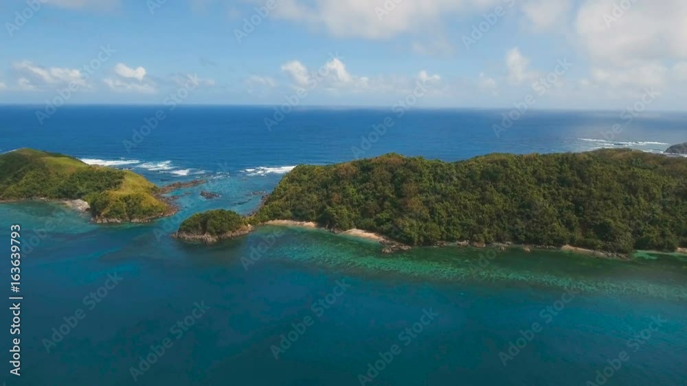 Aerial view:Tropical island with beach, mountains and the rainforest. Sea and the tropical island with rocks, beach and waves. Seascape: sky, clouds, rocks, ocean. 4K video. 4K video. Travel concept Aerial view:Tropical island with beach, mountains and the rainforest. Sea and the tropical island with rocks, beach and waves. Seascape: sky, clouds, rocks, ocean. 4K video. 4K video. Travel concept
