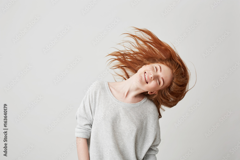 Φωτογραφία Portrait of young cheerful beautiful redhead girl smiling with closed eyes shaking head and hair over white background