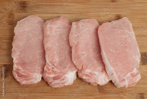 Pork chops on a wooden board