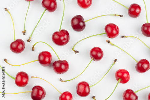Many red fresh cherries on white background