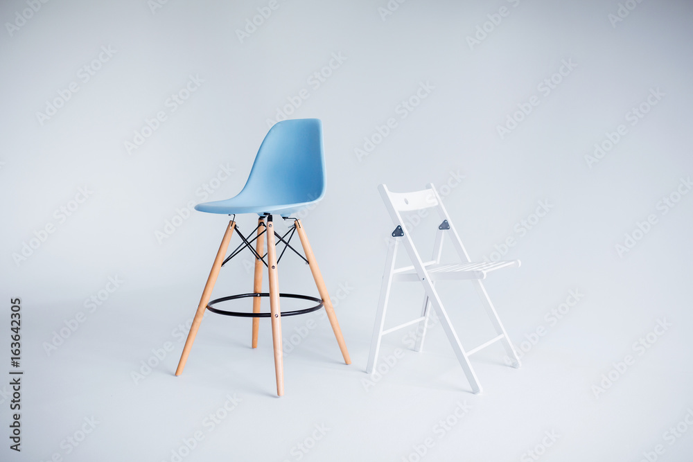 New modern chairs in white and blue standing in white room. New modern chairs in white and blue standing in white room.