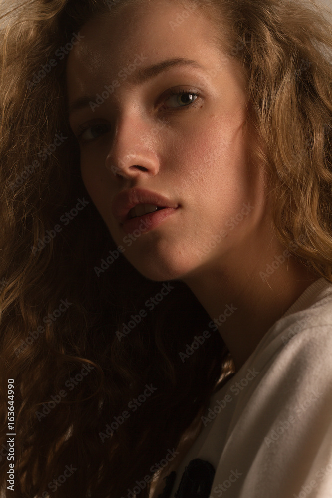 Beautiful girl portrait in studio with curly hair Beautiful girl portrait in studio with curly hair