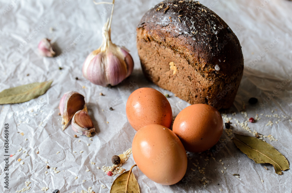 Still life of bread, eggs, garlic and spices. Still life of bread, eggs, garlic and spices.