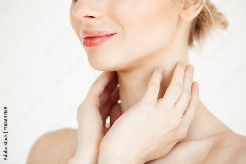 Close up of beautiful tender girl with clean healthy skin smiling over white background. Facial treatment.