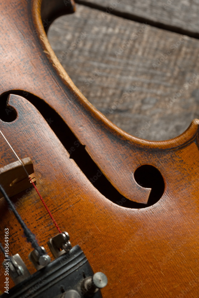Violin on a wooden textured table Violin on a wooden textured table