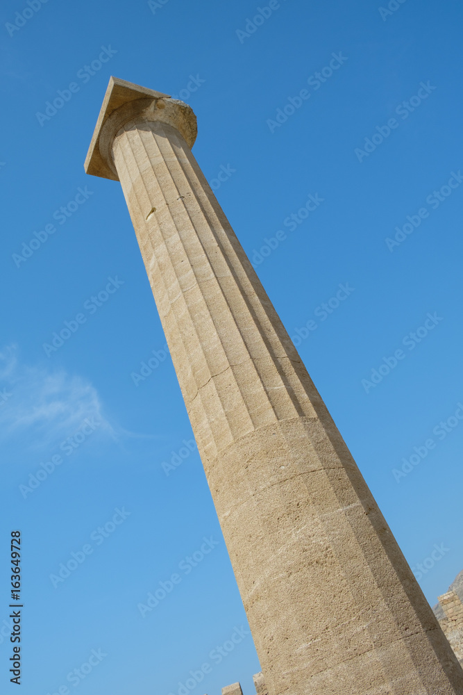 One of the pillars against the blue sky of the Doric temple of Athena Lindia on the Acropolis of Lindos. n the Acropolis of Lindos. Dodecanese Islands, Greek Islands, Greece, Europe