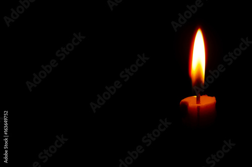isolated Burning Candle In The Dark