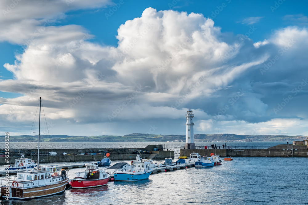 Edinburgh's Newhaven harbour with interesting cloud formations above. Scotland, UK 