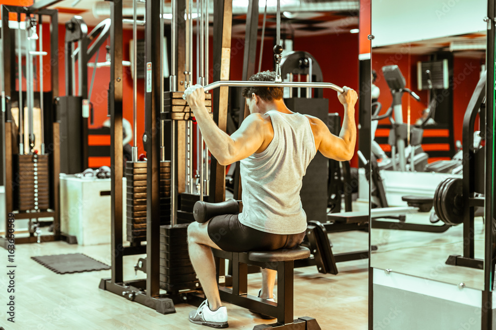 Fototapeta premium Man workingout in the local gym
