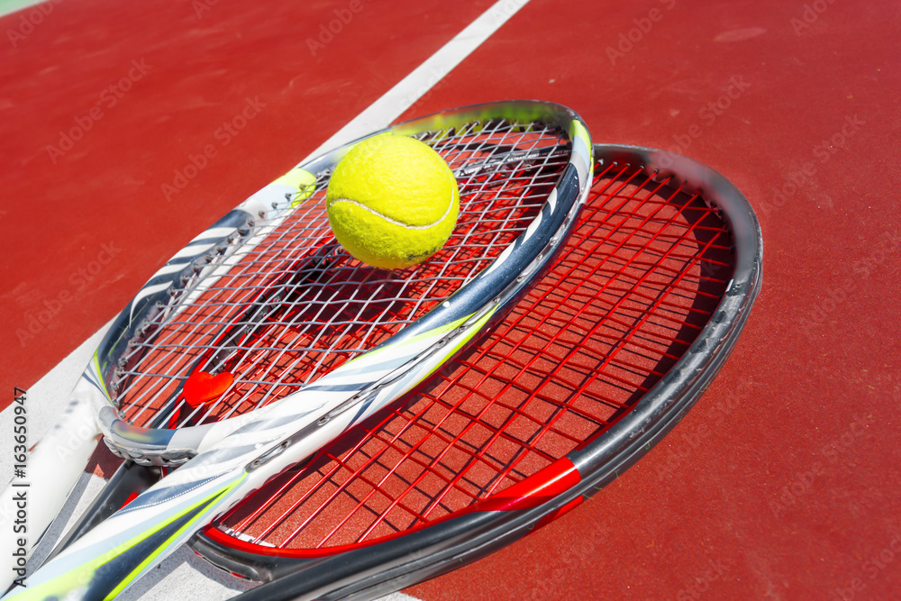 Tennis balls and racket on the grass court