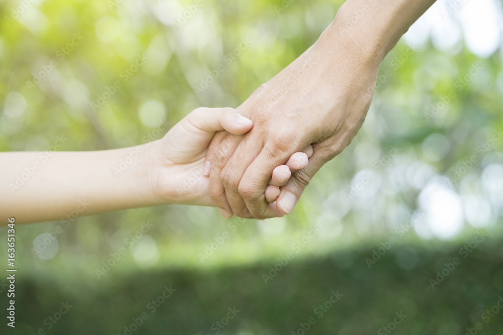 Mother holding a hand of his son in summer day Mother holding a hand of his son in summer day