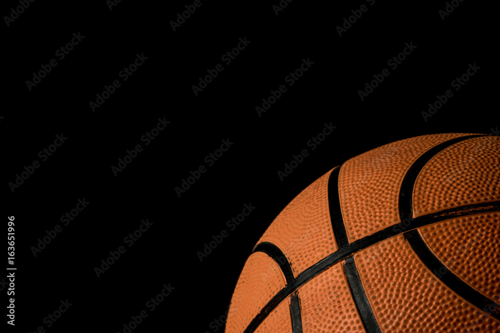 Fototapeta premium A single basketball isolated on a black background