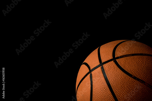 A single basketball isolated on a black background © Ben Gingell