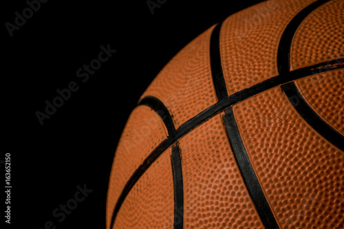 A single basketball isolated on a black background