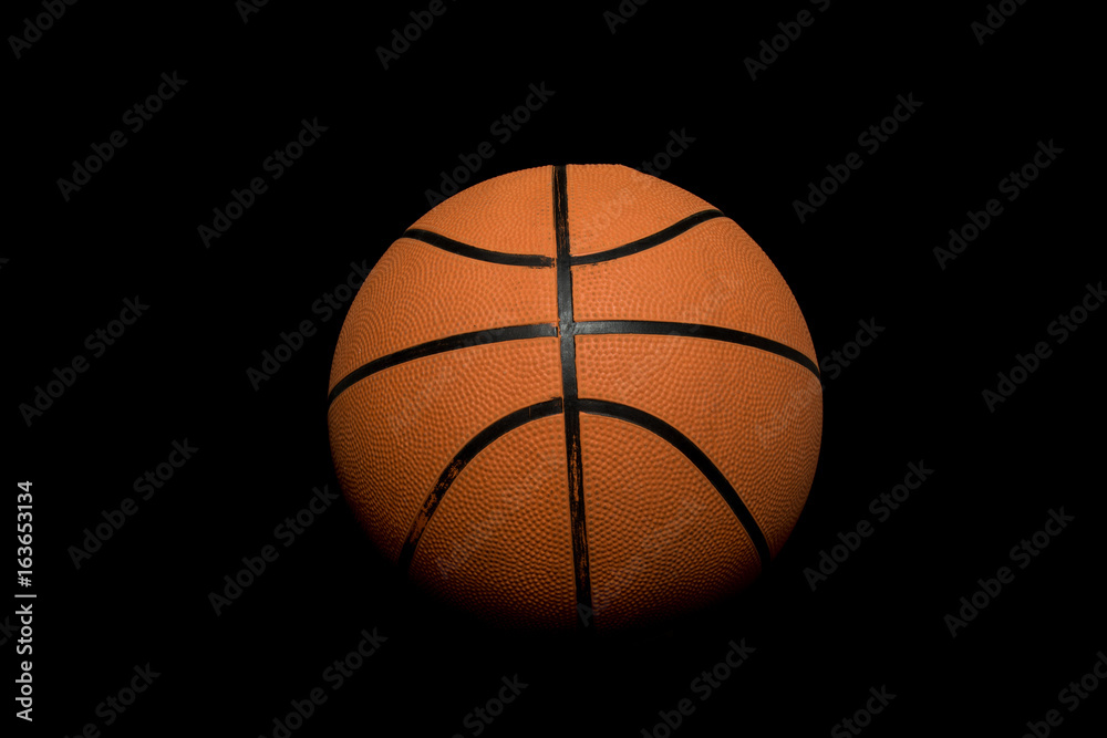 A single basketball isolated on a black background