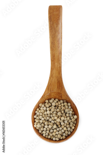 white peppercorn in wooden spoon isolated