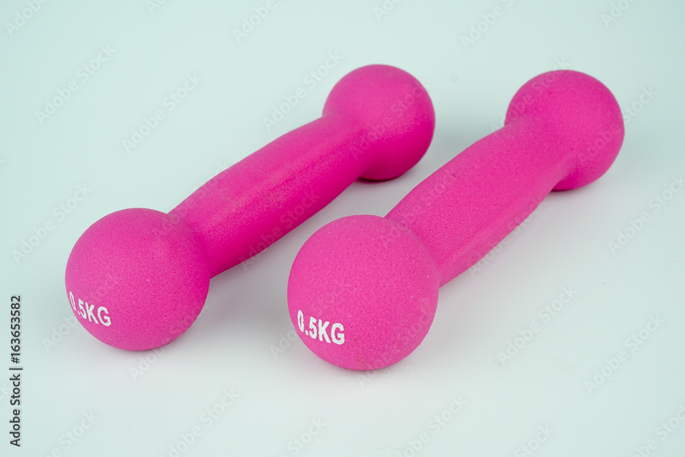 Pink dumbbells on white background.