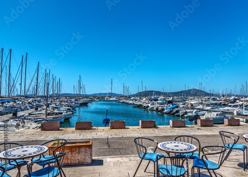 Tables and chairs by Alghero harbor