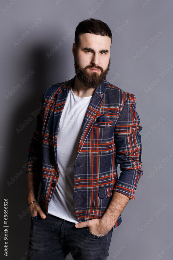 Handsome bearded man posing with hands in pocket Handsome bearded man posing with hands in pocket