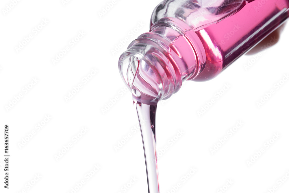 Cosmetic liquid pouring from bottle isolated on white background - obrazy, fototapety, plakaty 
