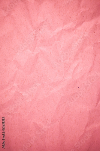 Crumpled recycle pink paper background.