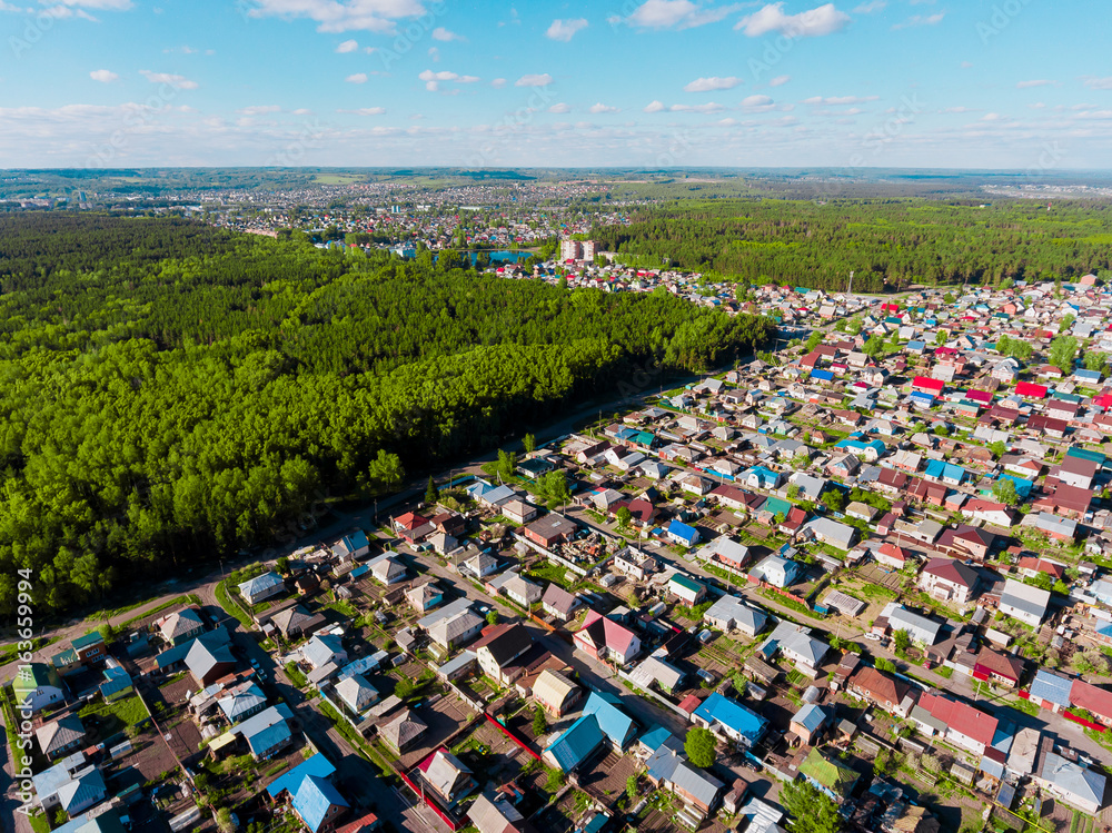 Panorama aerial view shot on cottage village in forest, suburb, village.