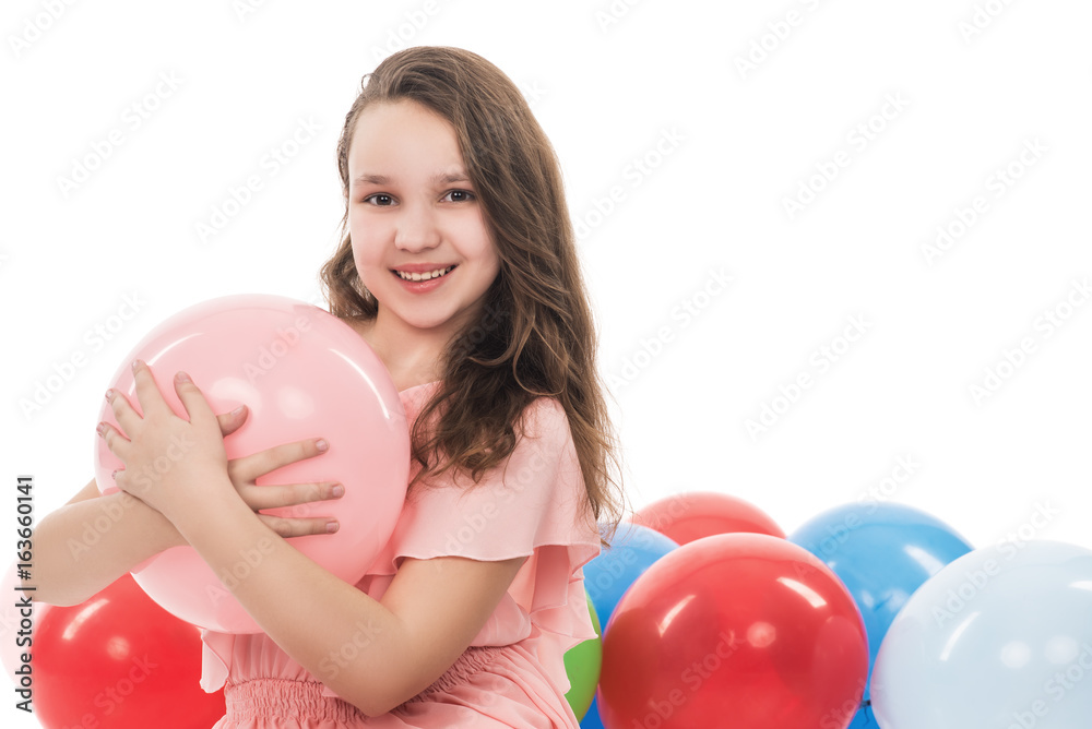 happy smiling young woman or teenage girl in pink dress with colorful helium air balloons, holidays concept, isolated on white background happy smiling young woman or teenage girl in pink dress with colorful helium air balloons, holidays concept, isolated on white background