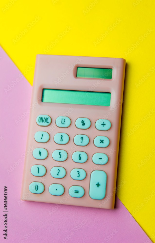Calculator on a pink and yellow background Calculator on a pink and yellow background