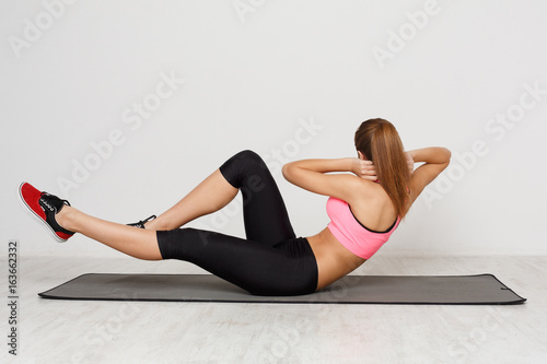 Fitness woman lying doing crunches