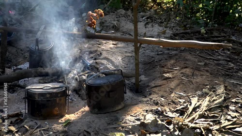 campfire with cooking equipment and smoky