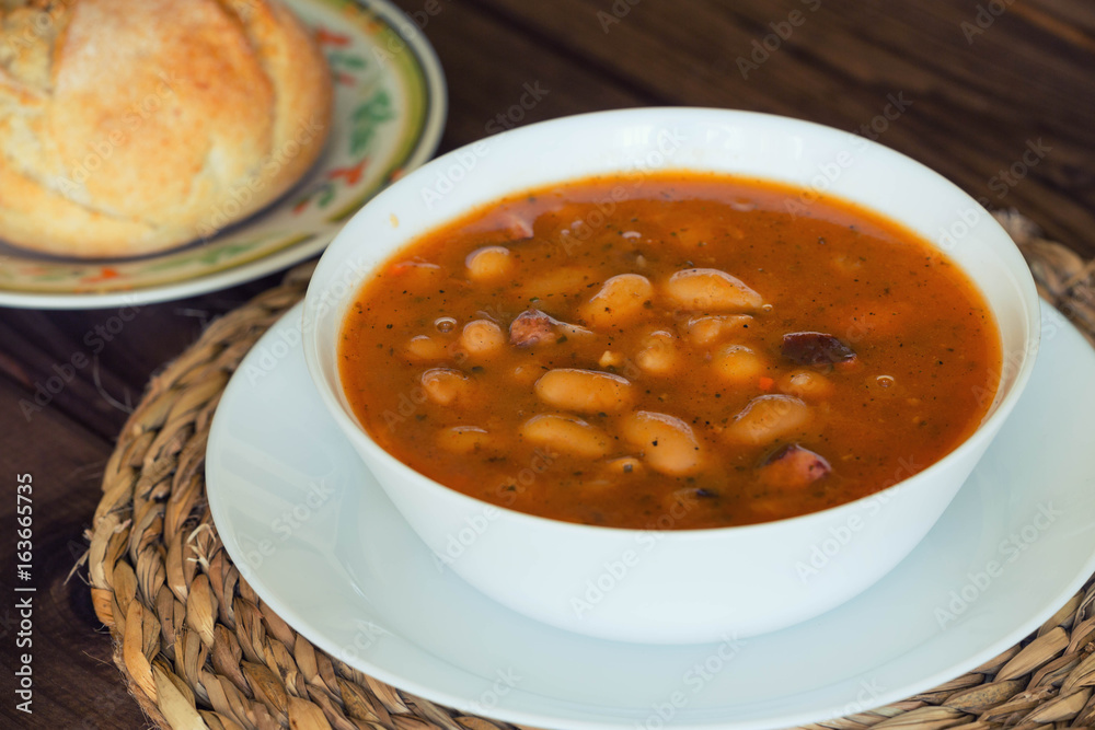 Bean soup with the buns on a wooden table. Bean soup with the buns on a wooden table.