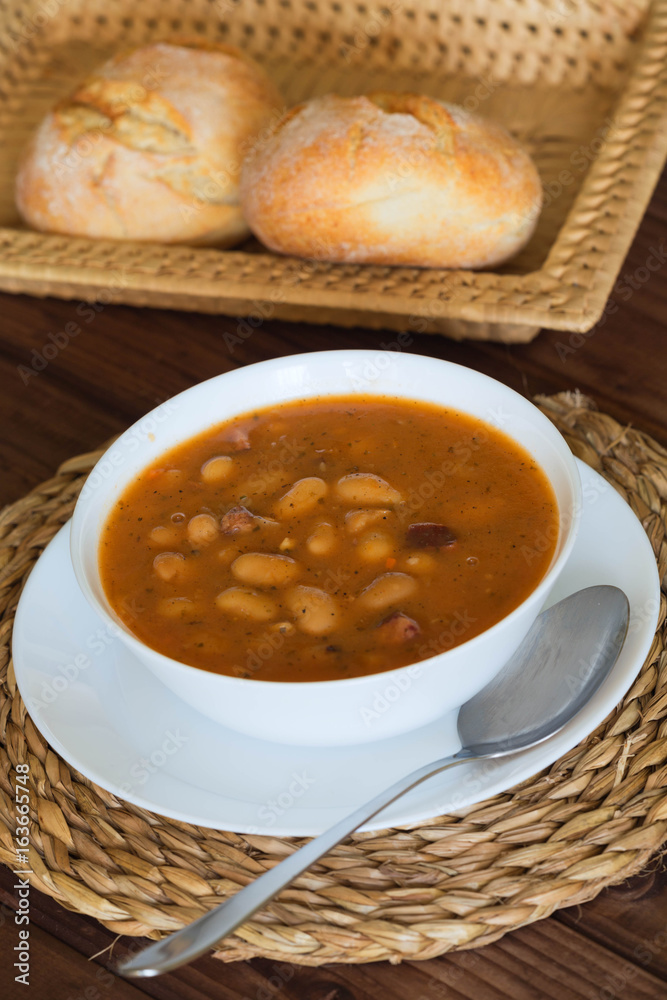 Bean soup with the buns on a wooden table. Bean soup with the buns on a wooden table.