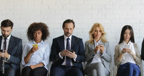 Group Of Business People Using Cell Smart Phones Sitting In Line, Mix Race Businesspeople Team Chatting And Surfing Web Slow Motion 60
