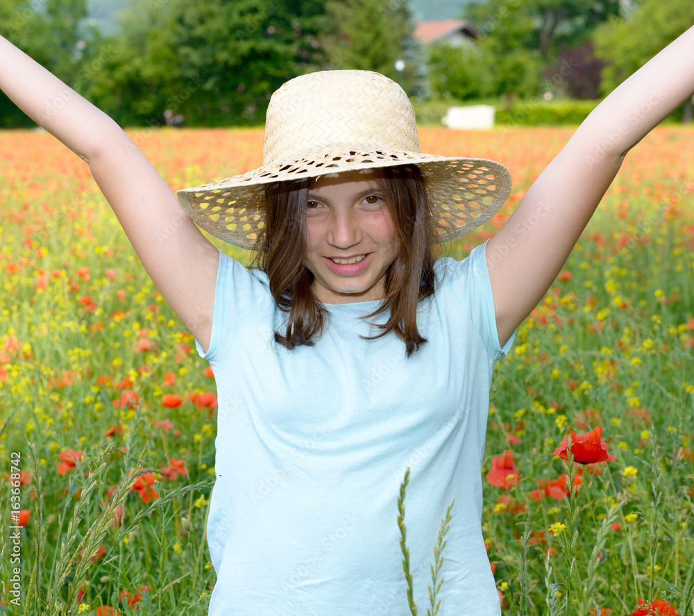 Young teenage girl in poppy field