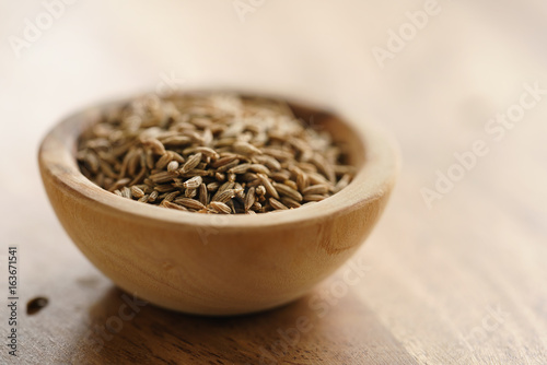cumin zira seeds in wood bowl on table