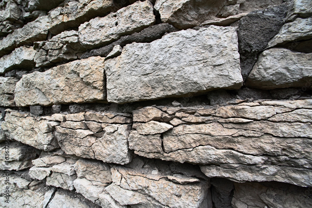 The stones of the old damaged wall are close The stones of the old damaged wall are close