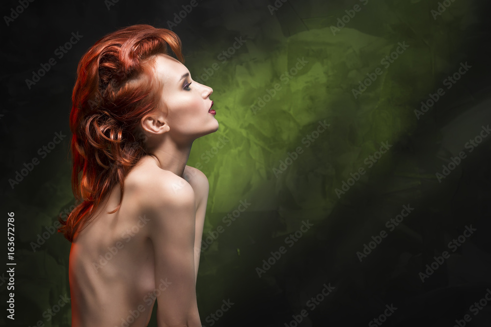Portrait of a redhead girl on a green gradient background