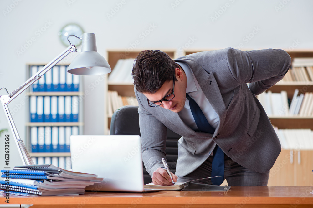 Businessman feeling pain in the office Businessman feeling pain in the office