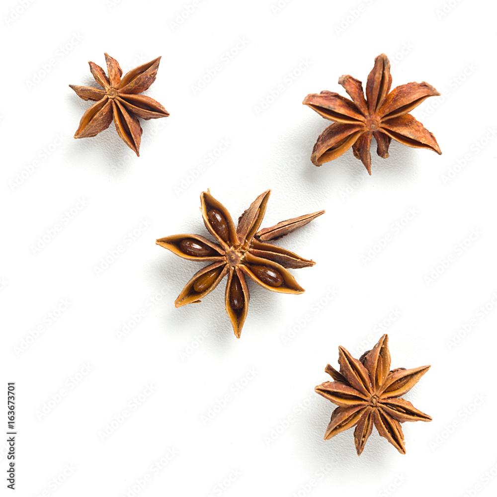 Star anise, scattered in a chaotic manner, isolated on white background