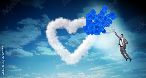 Man flying balloons in romantic concept