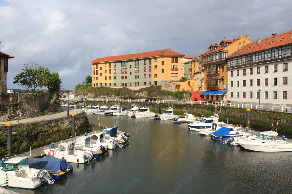 Llanes with boats in the port and some buildings