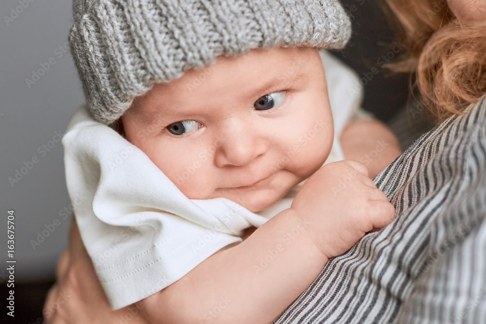 Small caucasian child, close up. Lady holding a baby. Raising the future. Small caucasian child, close up. Lady holding a baby. Raising the future.