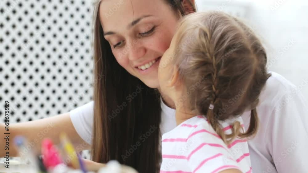 Mother and daughter doing a puzzle together in the light living room Mother and daughter doing a puzzle together in the light living room